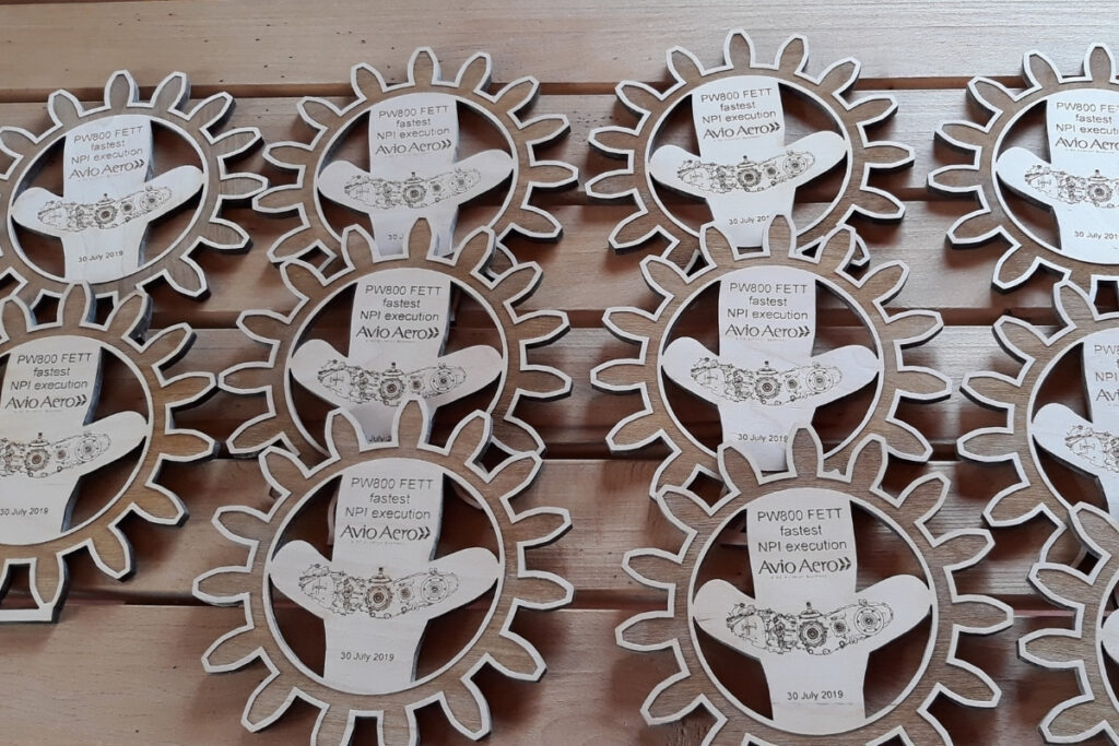Drewniany medal w kształcie łopatki wirnika silnika odrzutowego z grawerem technicznym i nazwą projektu inżynierskiego